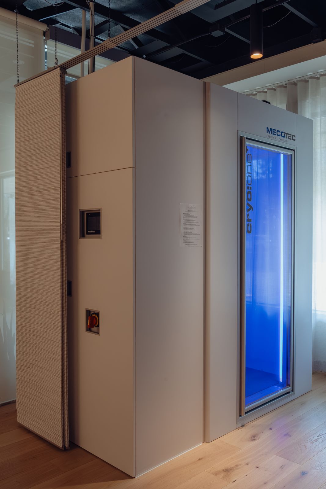 Mecotec cryo:one cryotherapy chamber with blue interior light